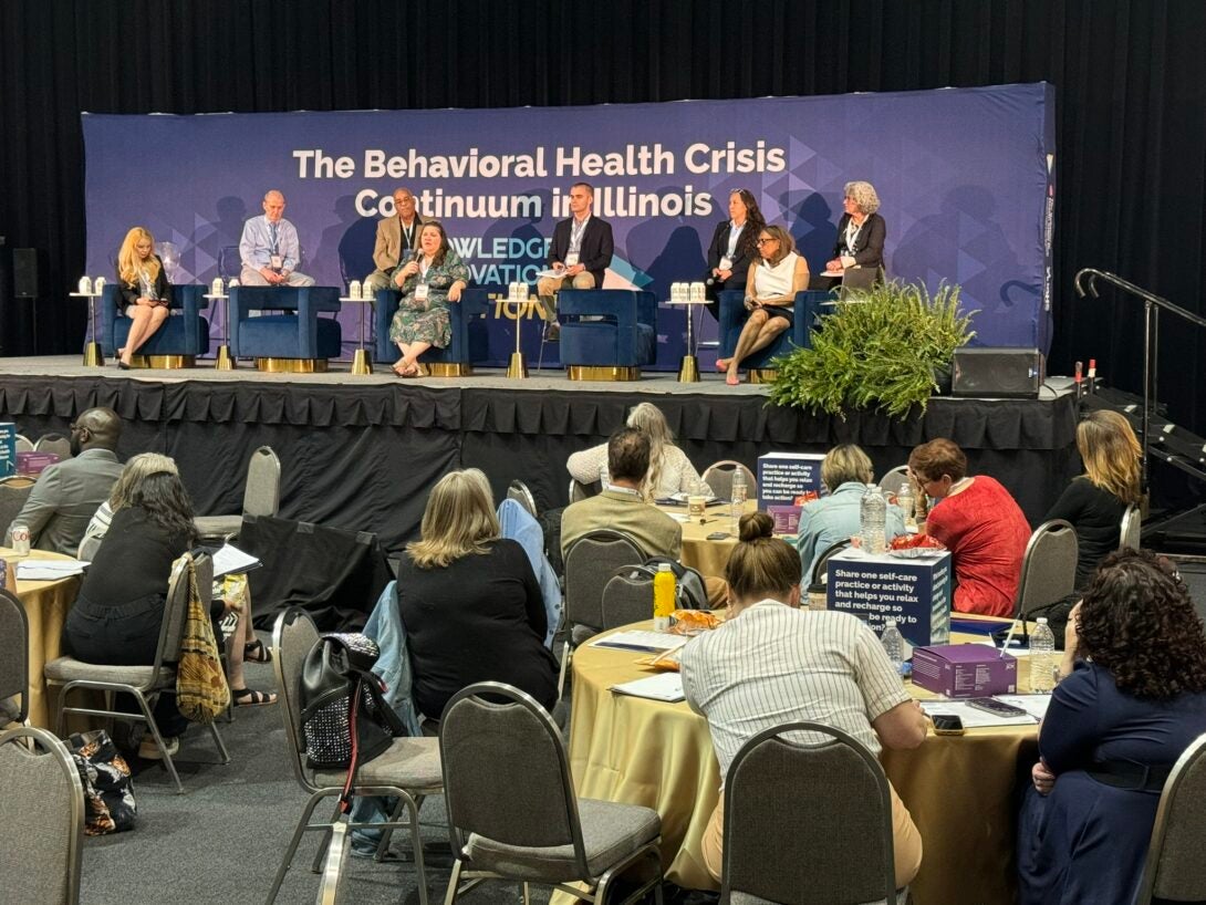 Speakers sit on stage. Left to Right Blanca Campos, Dr. Brian Hepburn, David Harris, Dr. Margie Balfour, Jackson Beck, Jodie Esquibel, Dr. Lorrie Jones, Anne Janks